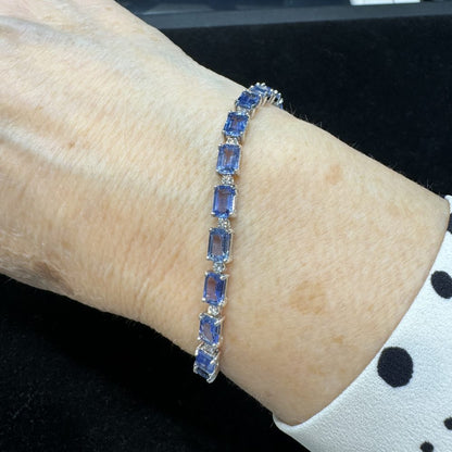 Fine Emerald Cut Sapphire and Diamond Bracelet, 23 emerald-cut sapphires alternated with 22 round brilliant-cut diamonds in 18ct white gold. Sapphires 26.99 carat total. Diamonds 0.44 carat total