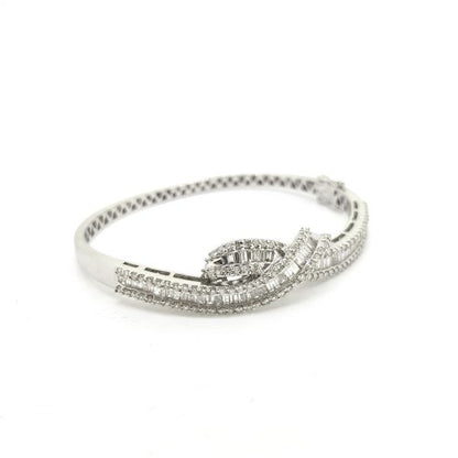 Diamond Crossover Twist Bangle Bracelet; set with 2.70 carats of baguette and brilliant-cut diamonds in an 18ct white gold contemporary twisted crossover design