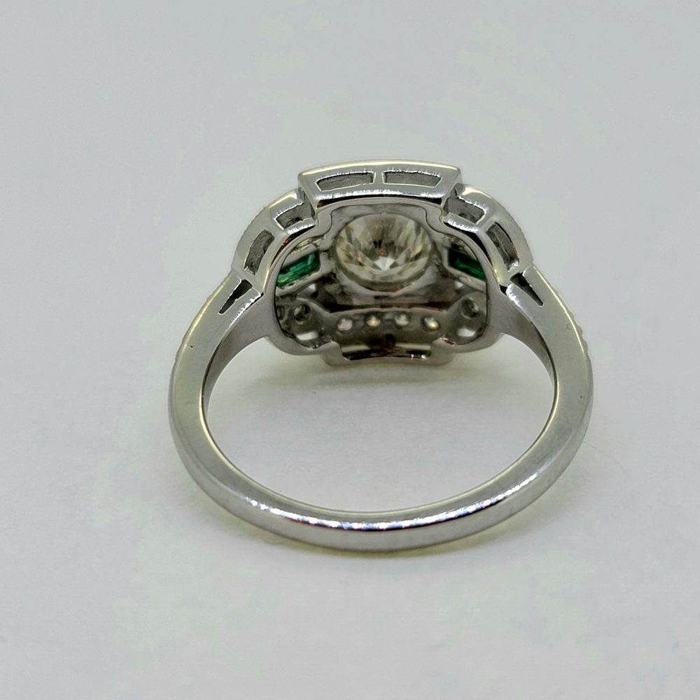 Vintage 0.96ct Diamond and Emerald Cluster Engagement Ring, 0.96ct diamond flanked top and bottom by diamond border in 18ct white gold with emerald and diamond fleur-de-lis shoulders