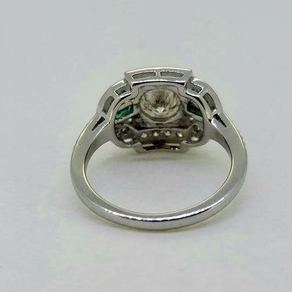 Vintage 0.96ct Diamond and Emerald Cluster Engagement Ring, 0.96ct diamond flanked top and bottom by diamond border in 18ct white gold with emerald and diamond fleur-de-lis shoulders