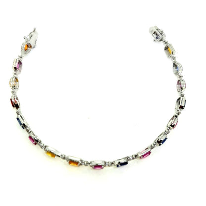 Multi Colour Sapphire and Diamond Cluster Line Bracelet, 18 eighteen mixed cut multi coloured sapphires surrounded by diamonds in 18ct white gold. Sapphires 7.72 carats. Diamonds 1.25 carats