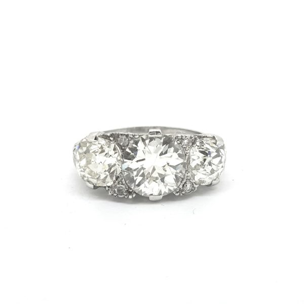 Vintage 1950s Diamond Three Stone Ring, 5.50 carat total, three brilliant-cut diamonds claw-set with delicate diamond accents, in 18ct white gold