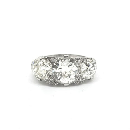 Vintage 1950s Diamond Three Stone Ring, 5.50 carat total, three brilliant-cut diamonds claw-set with delicate diamond accents, in 18ct white gold