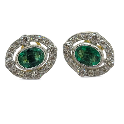 A pair of oval emerald and brilliant cut diamond oval cluster stud earrings in yellow and white gold