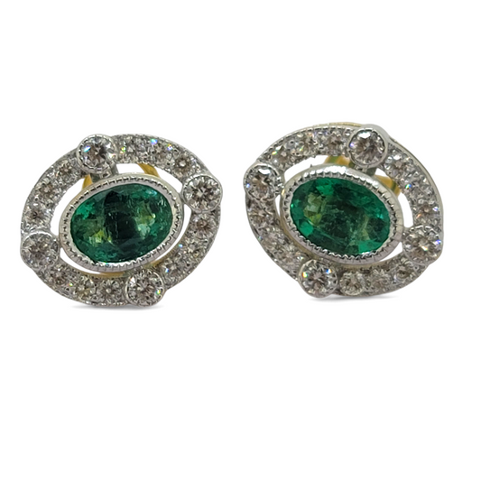 A pair of oval emerald and brilliant cut diamond oval cluster stud earrings in yellow and white gold