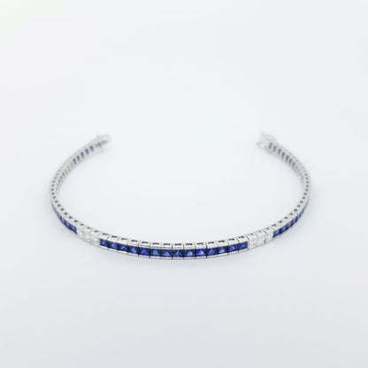 Princess Cut Sapphire and Diamond Line Bracelet; 6.58cts square-cut sapphires accented with 1.04cts princess-cut diamonds, in 18ct white gold
