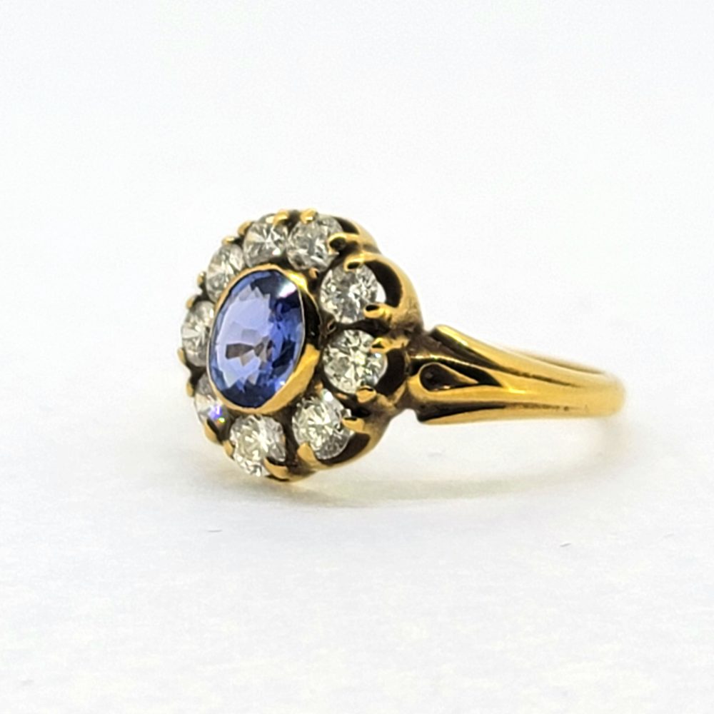 Antique Style Oval Sapphire and Diamond Cluster Engagement Ring, 0.80ct oval sapphire surrounded by 0.80cts sparkling diamonds in 18ct yellow gold with detailed shoulders