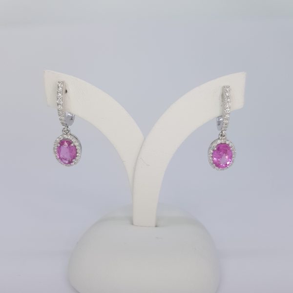 Pink Sapphire and Diamond Cluster Drop Earrings; featuring 2.01ct oval pink sapphires within diamond surrounds and suspended from diamond-set drops, in 18ct white gold