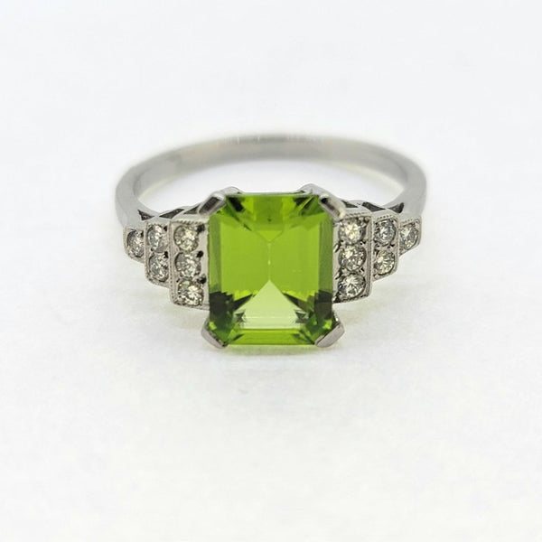 2.40ct Peridot and Diamond Engagement Ring in Platinum, 2.40ct emerald-cut peridot flanked by brilliant-cut diamond set stepped shoulders