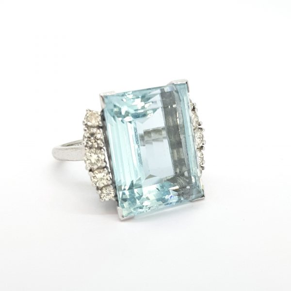 Aquamarine and Diamond Cocktail Ring; large 14 carat rectangular step-cut aquamarine flanked by 1cts diamonds, in 18ct white gold