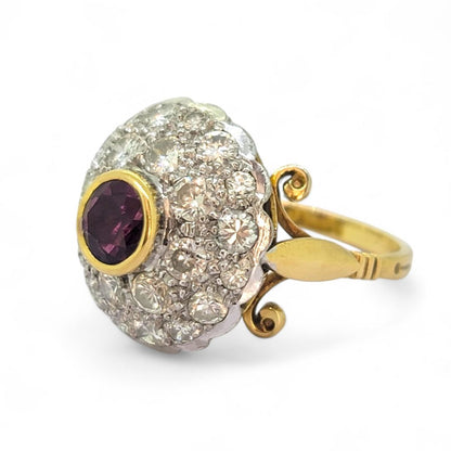 Ruby and Diamond Bombe Cluster Ring, central red ruby sits atop a domed bombe cluster of sparkling diamonds in white gold to an 18ct yellow gold shank with decorative scrolled shoulders