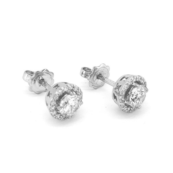 Diamond Halo Cluster Stud Earrings, 1.01 carat total, central round brilliant-cut diamonds encircled by a fixed diamond set halo surround, in 18ct white gold