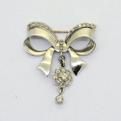 Diamond Set 18ct White Gold Bow Brooch, 1.50 carats, 18ct white gold bow set with diamonds which suspends diamond flower cluster drop