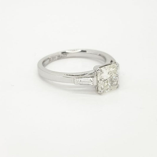 Radiant Cut Diamond Ring with Baguette Shoulders in Platinum; central 0.51 carat radiant-cut diamond flanked by 0.38cts baguette-cut diamonds to the shoulders