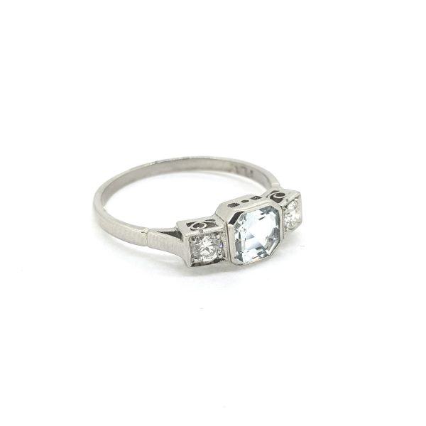 0.80ct Aquamarine and Diamond Three Stone Ring in Platinum; central 0.80 carat octagonal-cut aquamarine flanked by 0.20cts brilliant-cut diamonds