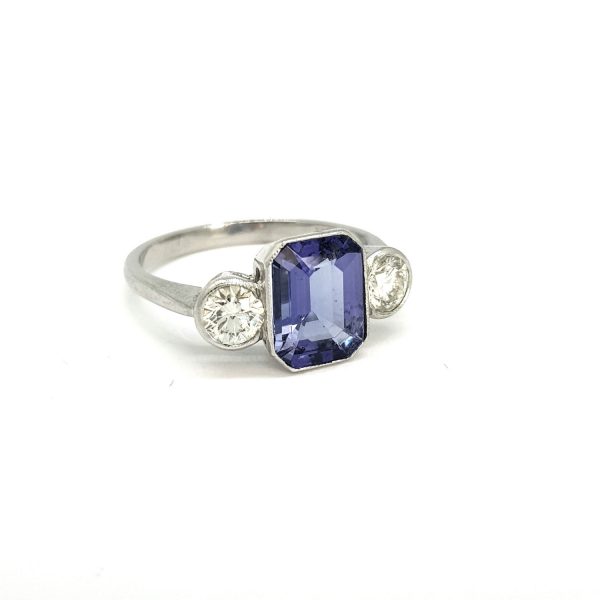 Tanzanite and Diamond Three Stone Ring in Platinum, central 2.20ct emerald-cut tanzanite flanked by 0.80cts brilliant-cut diamonds