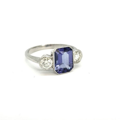 Tanzanite and Diamond Three Stone Ring in Platinum, central 2.20ct emerald-cut tanzanite flanked by 0.80cts brilliant-cut diamonds
