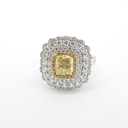 Yellow and White Diamond Cluster Ring; central GIA certified 1.00 carat cushion-shaped yellow diamond, surrounded by a halo of yellow diamonds and three further halos of sparkling white diamonds, in 18ct white gold