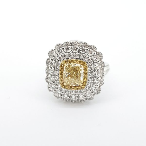 Yellow and White Diamond Cluster Ring; central GIA certified 1.00 carat cushion-shaped yellow diamond, surrounded by a halo of yellow diamonds and three further halos of sparkling white diamonds, in 18ct white gold