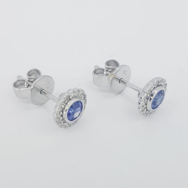 Sapphire and Diamond Cluster Stud Earrings; featuring 0.40cts Madagascan sapphires with 0.10cts brilliant cut diamond surrounds, in 18ct white gold