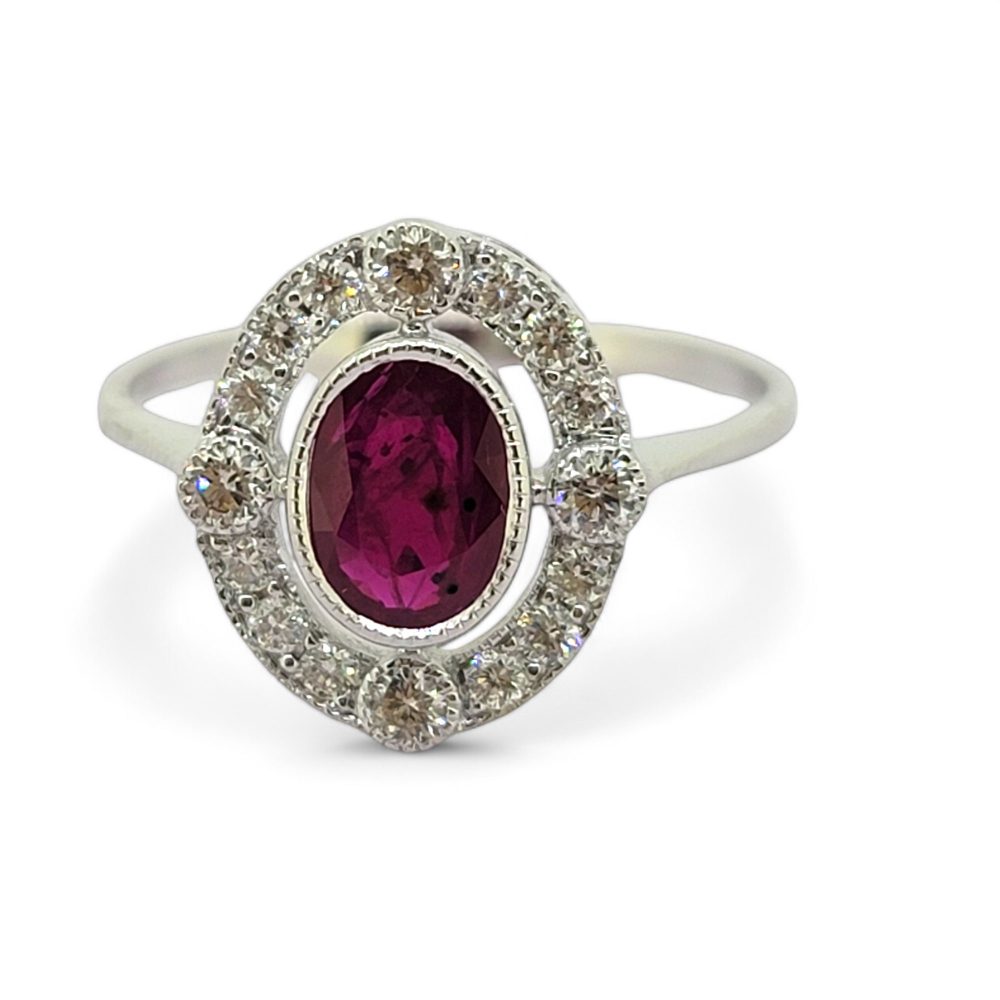 Ruby and Diamond Halo Cluster Engagement Ring, 0.70ct oval red ruby surrounded by fixed halo of diamonds with larger diamonds at the four compass points in 18ct white gold
