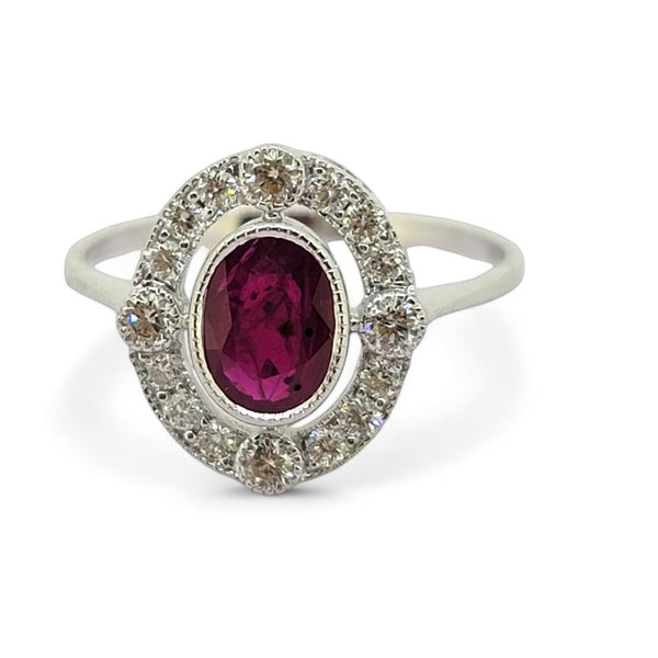 Ruby and Diamond Halo Cluster Engagement Ring, 0.70ct oval red ruby surrounded by fixed halo of diamonds with larger diamonds at the four compass points in 18ct white gold