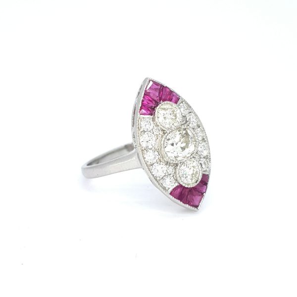 Ruby and Diamond Marquise Shaped Navette Cluster Ring in Platinum; three central diamonds within a diamond surrounded accented with calibre-cut rubies to the tips