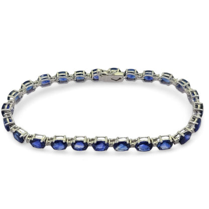 Oval Cut Sapphire and Diamond Line Bracelet, 14.97 carats of oval-cut blue sapphires accented with sparkling diamonds between in 18ct white gold