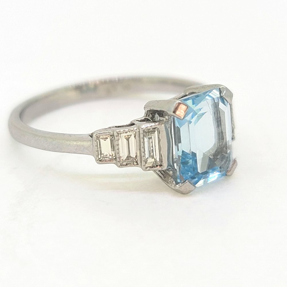 1.20ct Aquamarine and Diamond Engagement Ring in Platinum, 1.20ct emerald-cut aquamarine flanked by graduated stepped baguette-cut diamonds to the sides