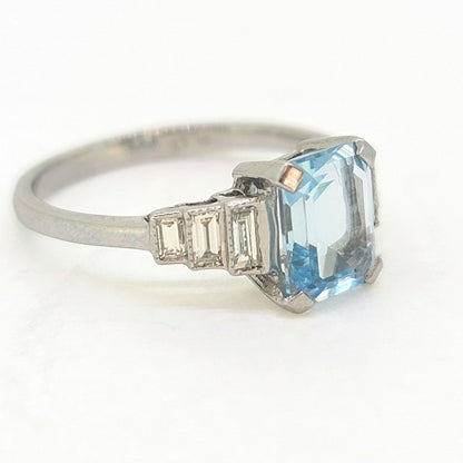 1.20ct Aquamarine and Diamond Engagement Ring in Platinum, 1.20ct emerald-cut aquamarine flanked by graduated stepped baguette-cut diamonds to the sides