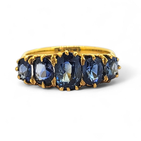 Antique Style Natural Sapphire Five Stone Ring, composed of five graduated oval blue sapphire claw set and mounted in 18ct yellow gold