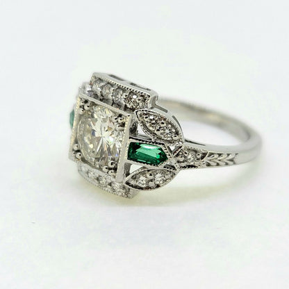 Vintage 0.96ct Diamond and Emerald Cluster Engagement Ring, 0.96ct diamond flanked top and bottom by diamond border in 18ct white gold with emerald and diamond fleur-de-lis shoulders