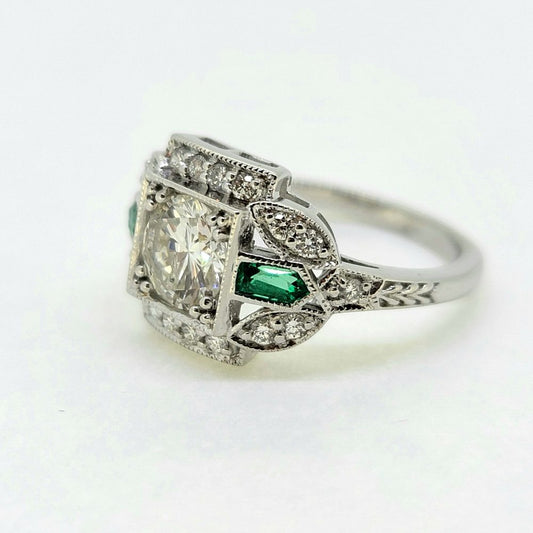 Vintage 0.96ct Diamond and Emerald Cluster Engagement Ring, 0.96ct diamond flanked top and bottom by diamond border in 18ct white gold with emerald and diamond fleur-de-lis shoulders