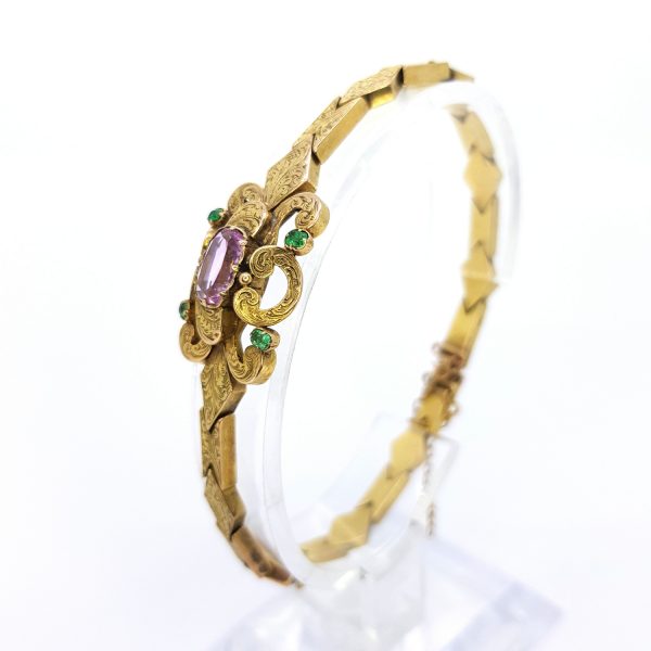 Antique Victorian Pink Topaz and Emerald set 15ct Gold Bracelet; central oval faceted pink topaz is set within scrolled design with a circular cut emerald to each corner