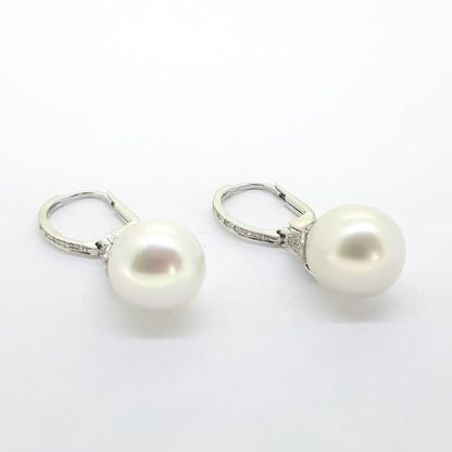 Pearl and Diamond Drop Earrings; featuring pearls suspended from diamond set drops, Mounted in 18ct white gold