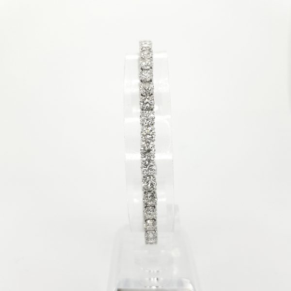 Diamond Line Bracelet in 18ct White Gold, 12.30 carat total; forty claw-set round brilliant-cut diamonds, gold push clasp opener and 'D' clip safety catch, 17.5cm in length