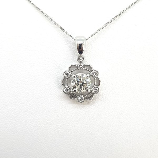 0.70ct Diamond Floral Pendant in 18ct White Gold; central 0.70 carat round brilliant-cut diamond, four-claw set, surrounded by six smaller collet-set diamonds