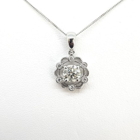 0.70ct Diamond Floral Pendant in 18ct White Gold; central 0.70 carat round brilliant-cut diamond, four-claw set, surrounded by six smaller collet-set diamonds