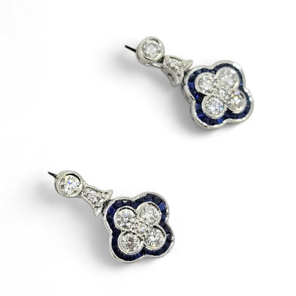 Diamond and Sapphire Quatrefoil Cluster Drop Earrings, Diamonds arranged in a quatrefoil design surrounded by calibre sapphire border with diamond stud tops