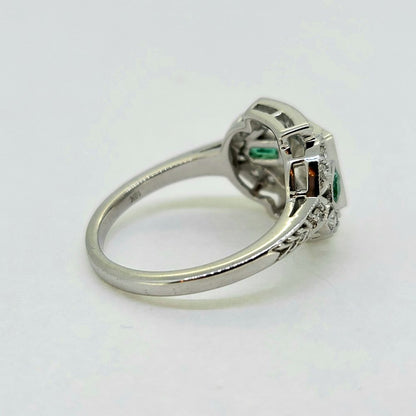 Vintage 0.96ct Diamond and Emerald Cluster Engagement Ring, 0.96ct diamond flanked top and bottom by diamond border in 18ct white gold with emerald and diamond fleur-de-lis shoulders