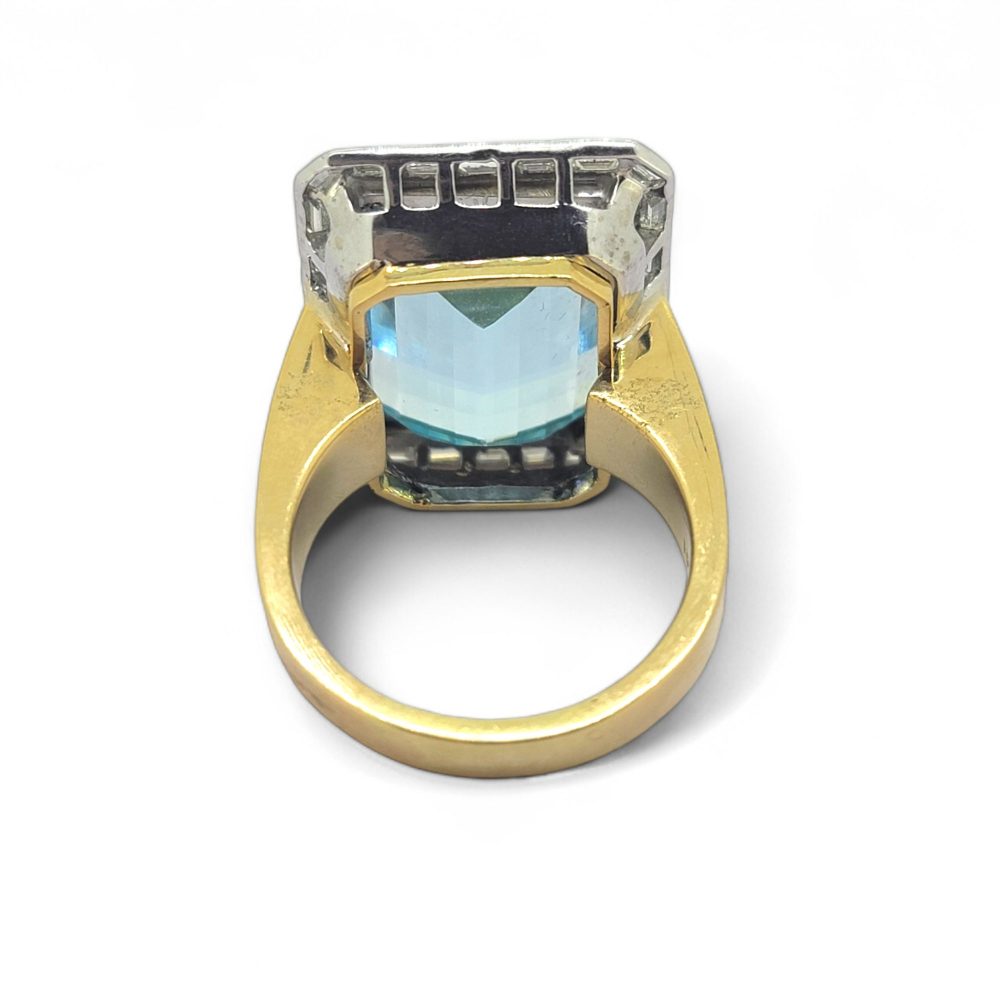 25ct Aquamarine and Baguette Diamond Cluster Ring, large 25cts emerald-shaped step-cut aquamarine bezel set in yellow gold with outer border of baguette-cut diamonds