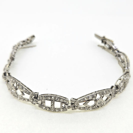 An Art Deco diamond link bracelet, clasp open, on a white background