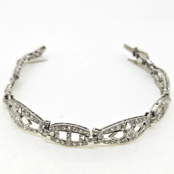 An Art Deco diamond link bracelet, clasp open, on a white background