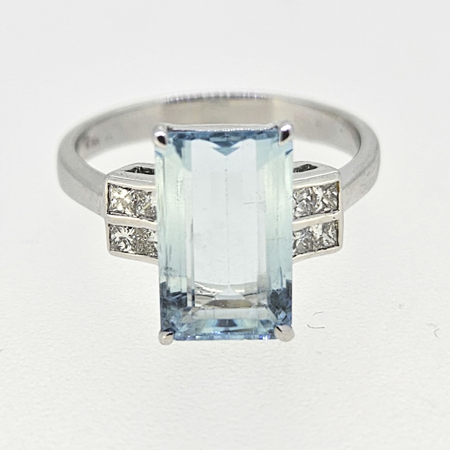 An emerald cut aquamarine and diamond ring in white gold