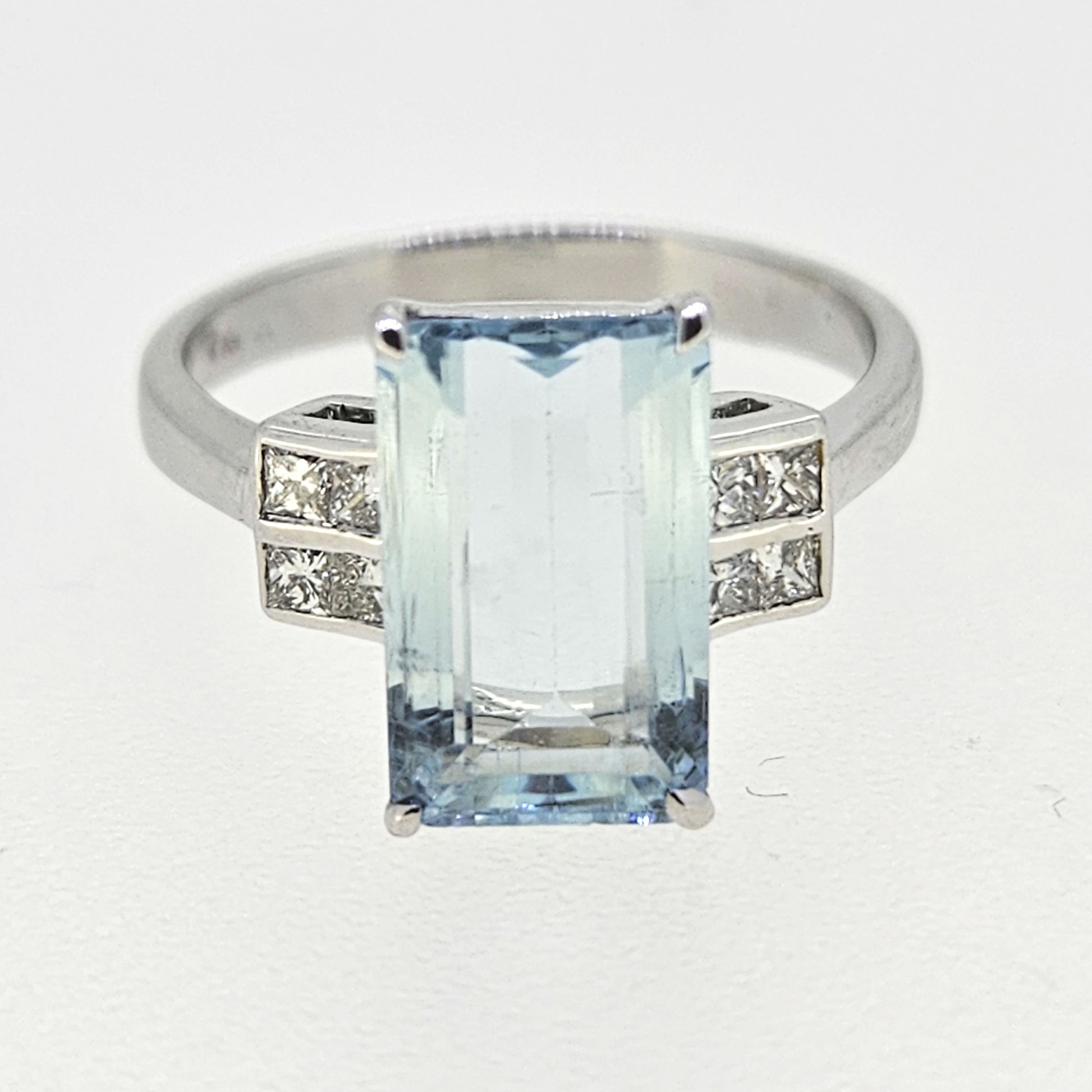 An emerald cut aquamarine and diamond ring in white gold