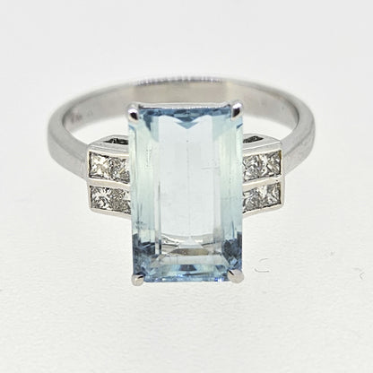 An emerald cut aquamarine and diamond ring in white gold