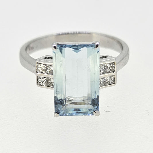 An emerald cut aquamarine and diamond ring in white gold