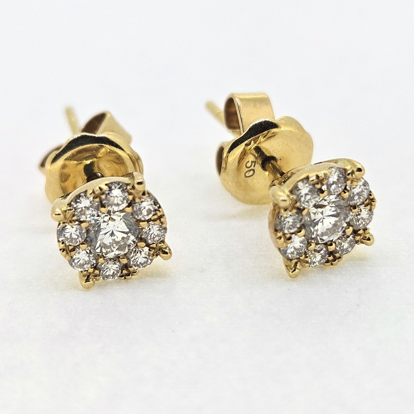 Diamond cluster studs earrings in 18ct yellow gold, on a white background