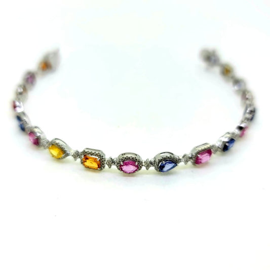 7.72ct Multi Colour Sapphire and Diamond Cluster Line Bracelet, 18 eighteen mixed cut multi coloured sapphires surrounded by diamonds in 18ct white gold. Sapphires 7.72 carats. Diamonds 1.25 carats