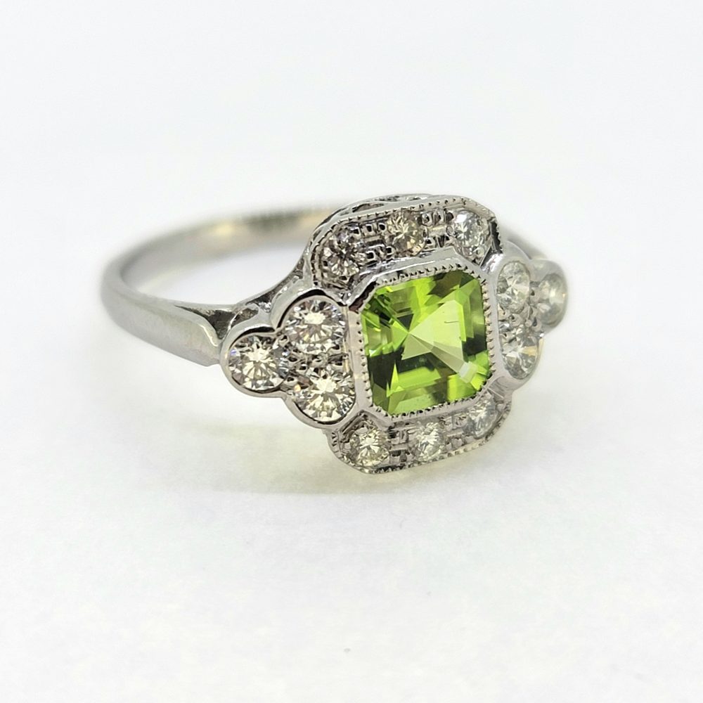 1ct Peridot and Diamond Cluster Ring in Platinum, 1ct peridot within decorative 0.55cts diamond set platinum mount